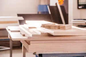 Stacks of unfinished MDF and engineered wood boards in a furniture workshop.