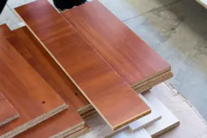 Disadvantages of MDF furniture shown by chipped laminate and exposed particleboard edges.