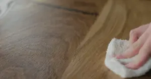 Someone dusting and polishing their wood furniture.