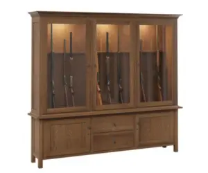 Large solid wood Amish gun cabinet with glass doors, interior lighting, drawers, and lower storage.