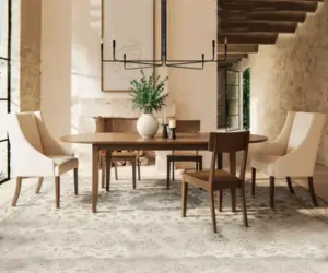 Solid wood dining table surrounded by upholstered and wooden dining chairs.